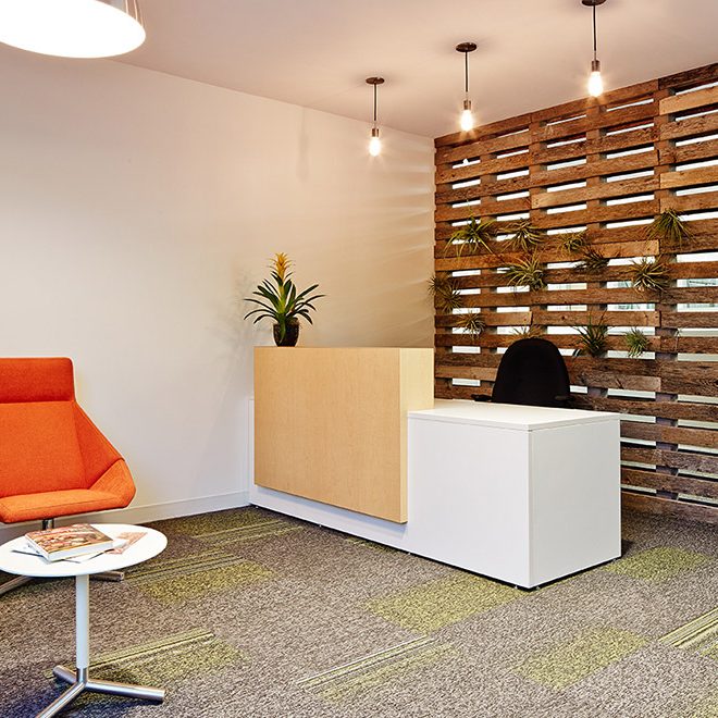 office reception with wooden pallet wall | Rossi Builders Photos