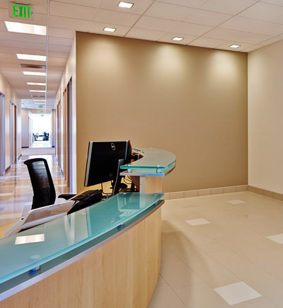 reception desk with glass top in renovated healthcare office | Rossi Builders Photos